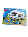 LEGO City Holiday Camping Van set 60283, shown in its original retail packaging against a plain white background. The box features a detailed illustration of the assembled white and blue van along with various camping accessories and minifigures.
